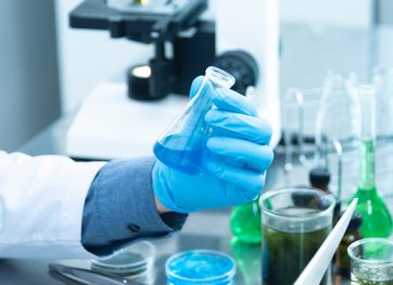 hand holding blue liquid in test tube