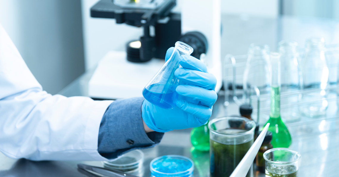 hand holding blue liquid in test tube